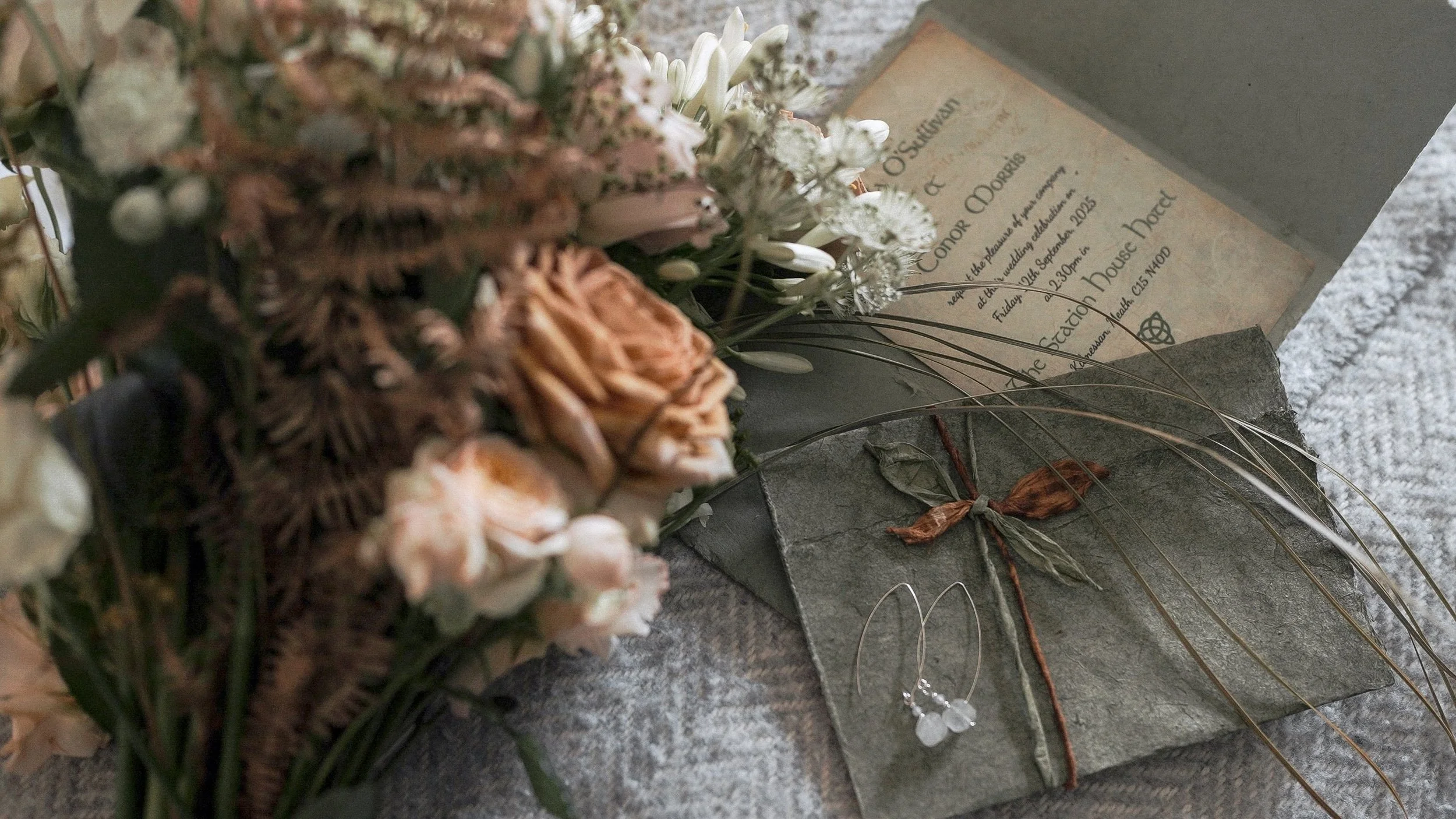 Wedding invitation, drop earrings and a bouquet of peach roses and copper fern – Station House Hotel wedding, Kilmessan