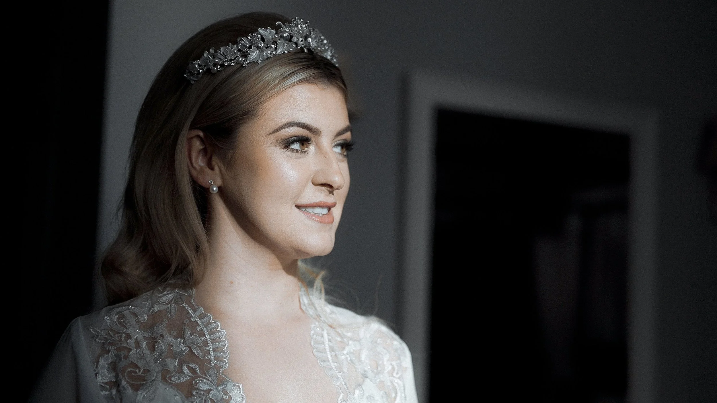Portrait of bride Hannah in a silver tiara and pearl earrings before her Armada Hotel wedding