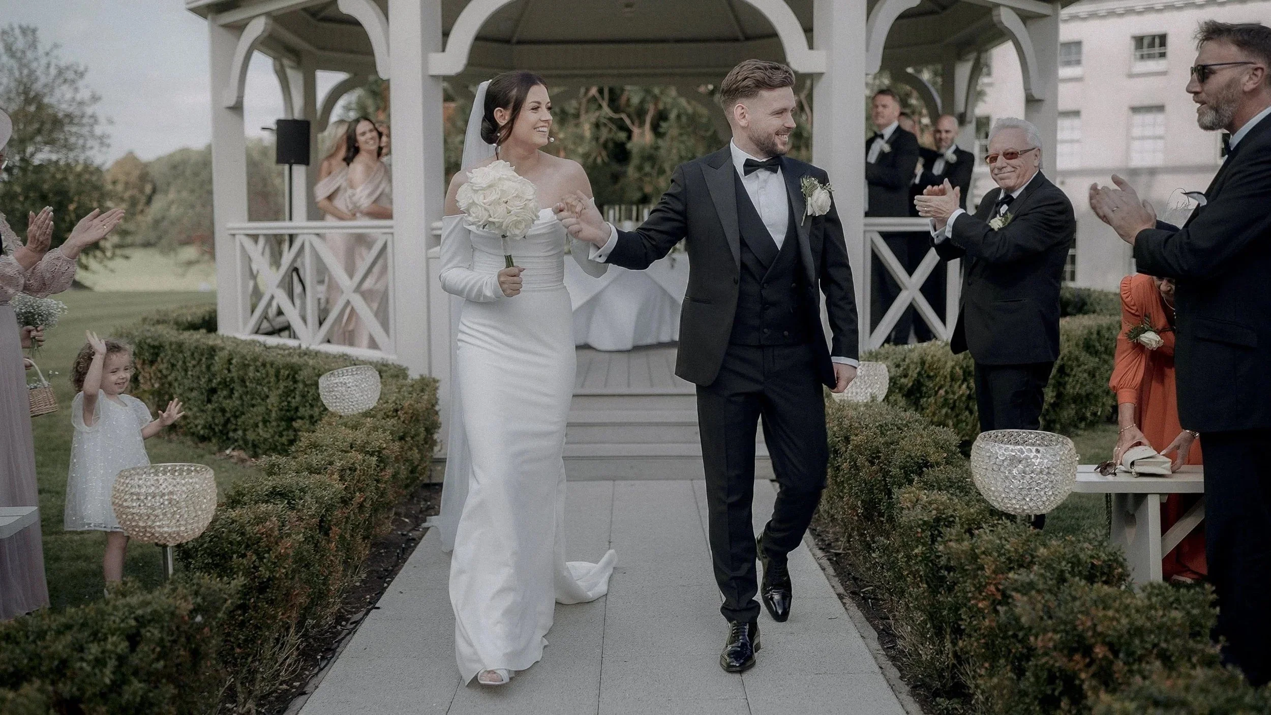 Jennie and Craig walking back down the aisle from the gazebo at their Farnham Estate wedding