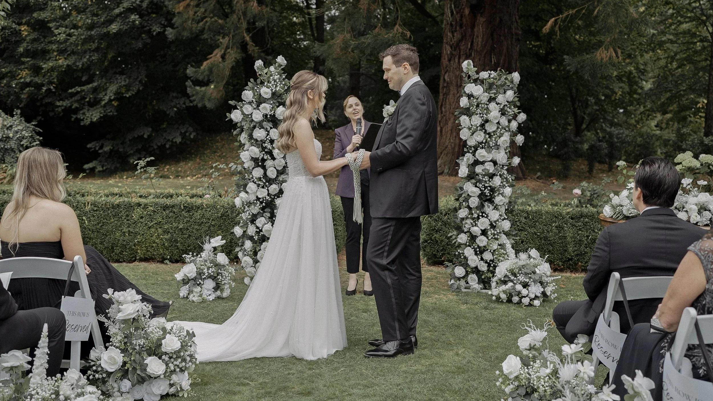 Handfasting with a braided cord during the outdoor ceremony at Tinakilly House, Co. Wicklow