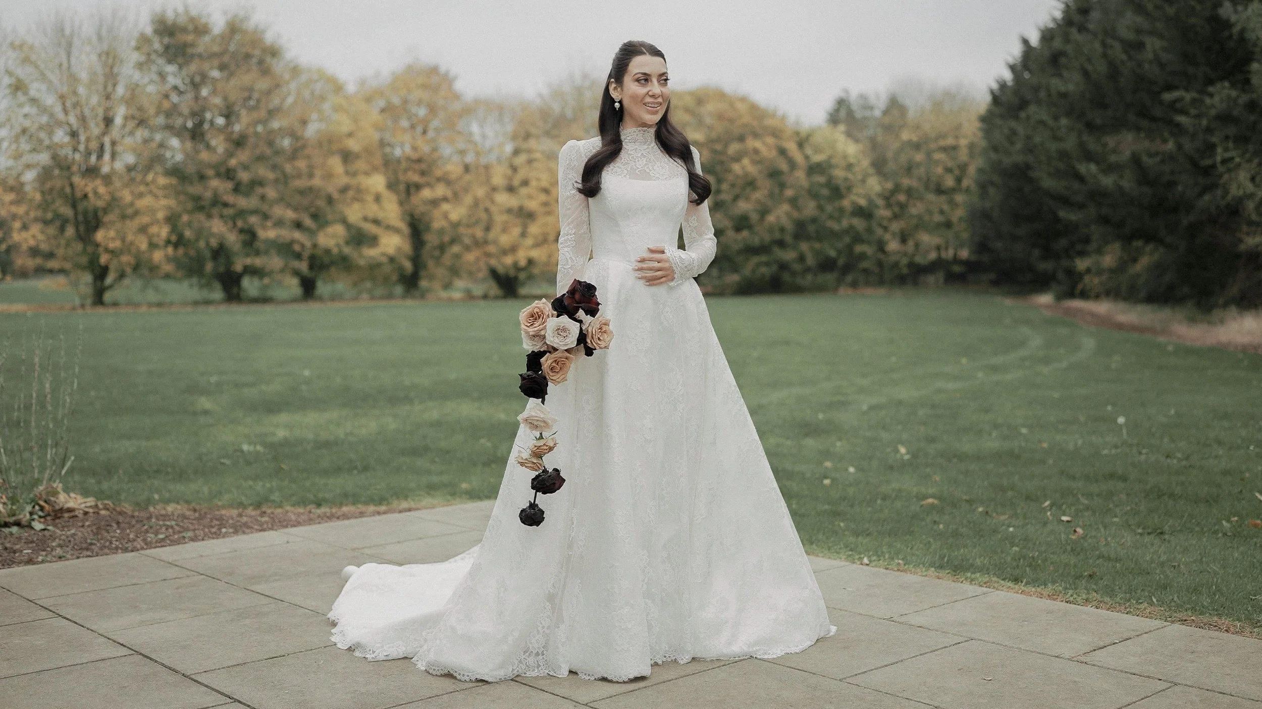 Bride with a cascading rose bouquet on the autumn lawns of Kilkea Castle, Co. Kildare