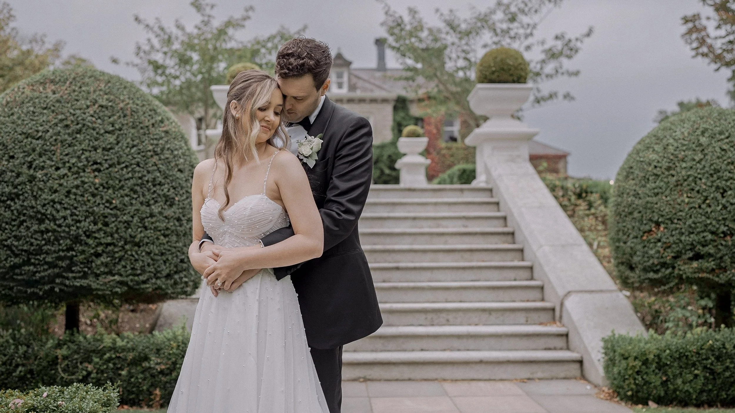 Catherine and Chris embracing by the garden steps at Tinakilly House, Wicklow
