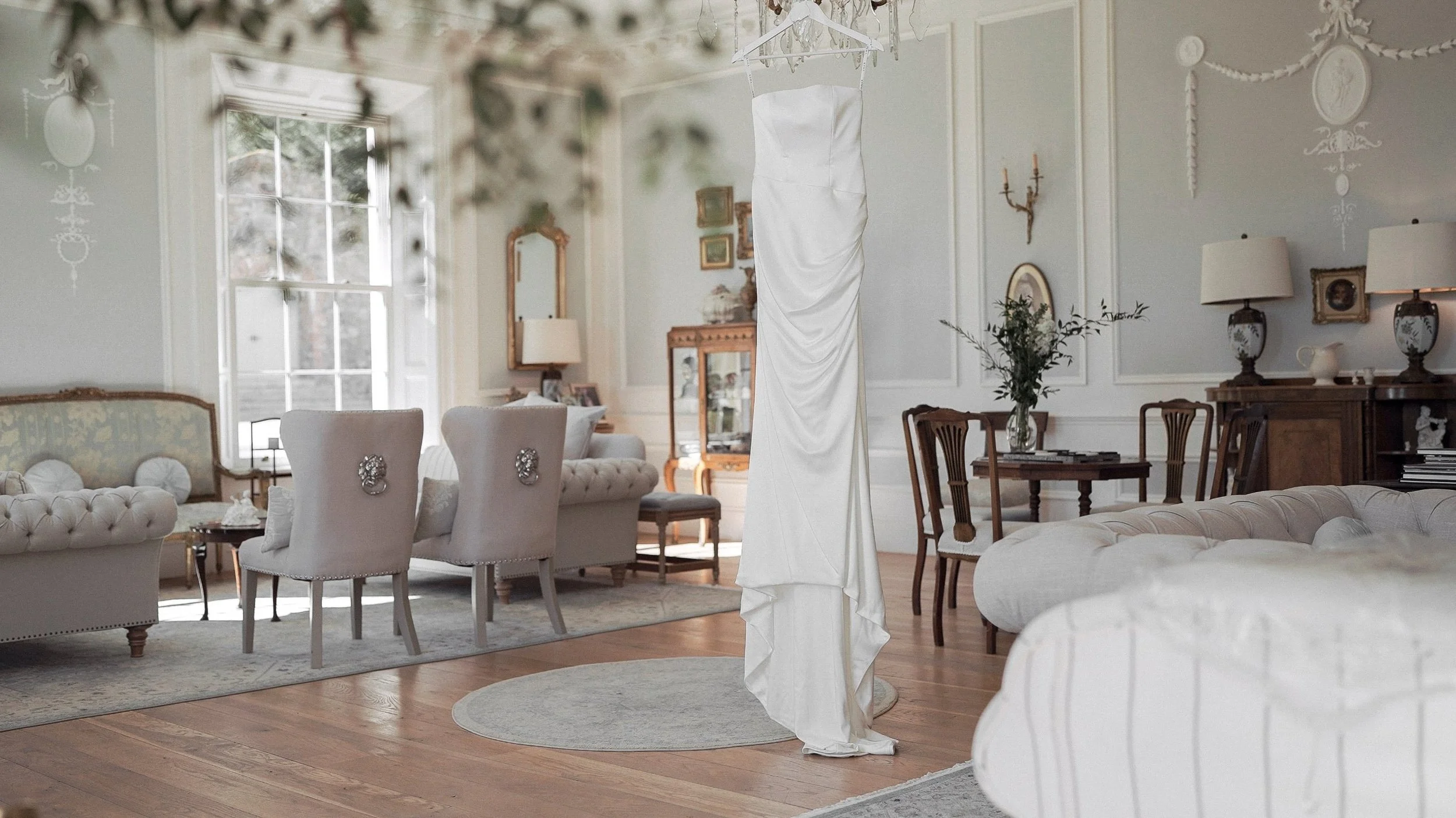 Satin wedding dress hanging in the drawing room of Clonwilliam House, Co. Wicklow