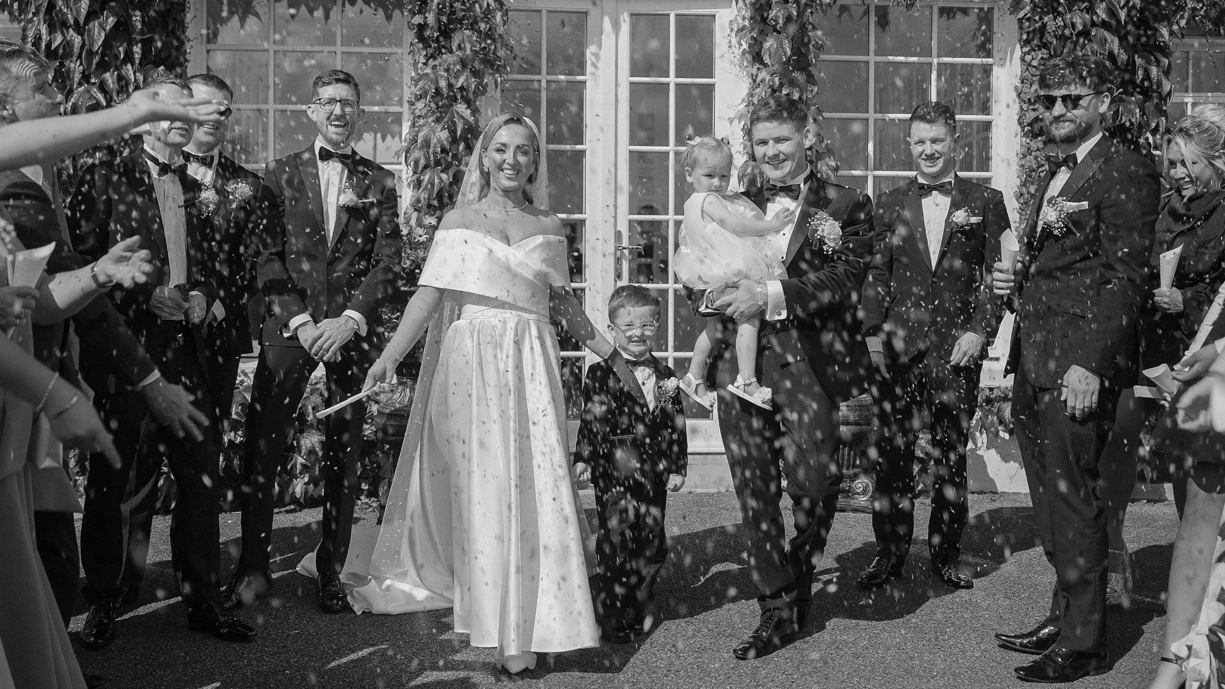 Black and white confetti exit with the bride, groom, page boy and flower girl at Crover House Hotel, Cavan