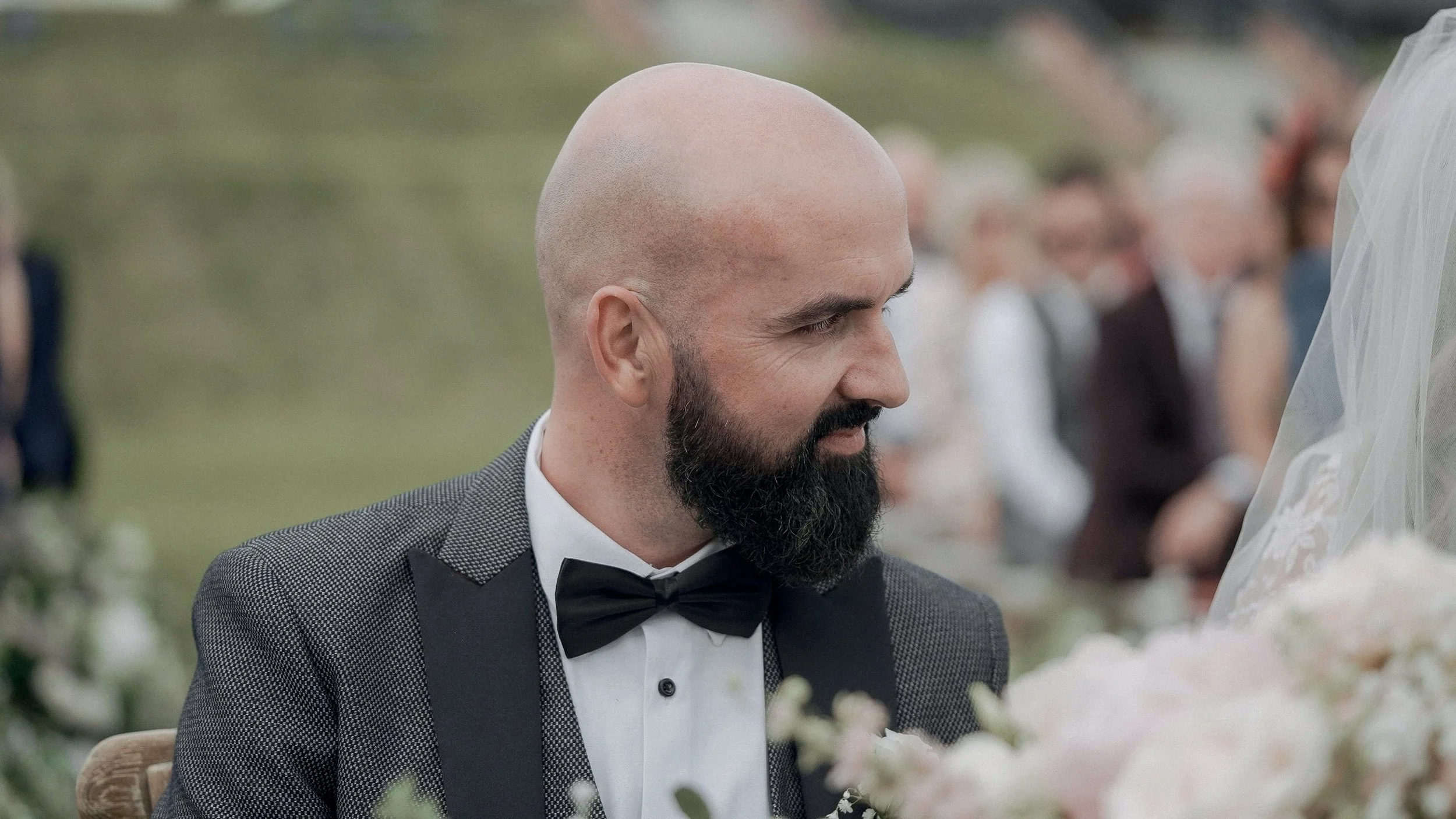 Groom smiling at his bride during the wedding ceremony at Glasson Lakehouse, Athlone