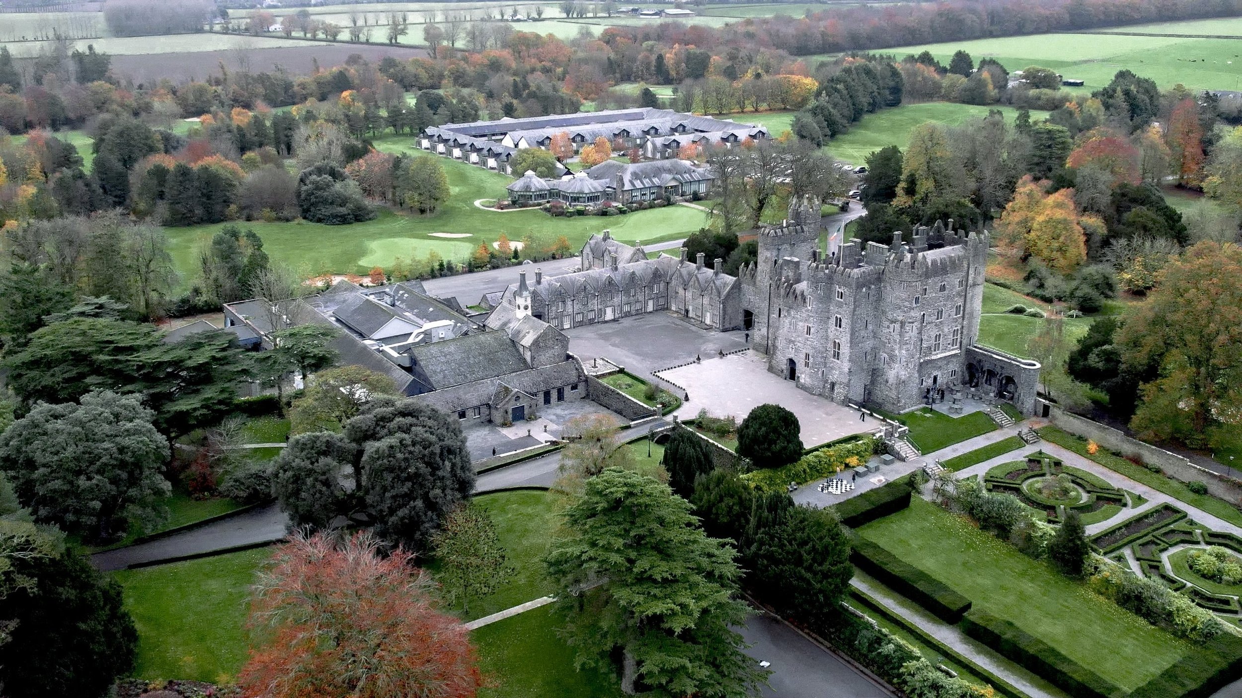 Aerial view of Kilkea Castle, its formal gardens and golf course in autumn, Castledermot, Co. Kildare