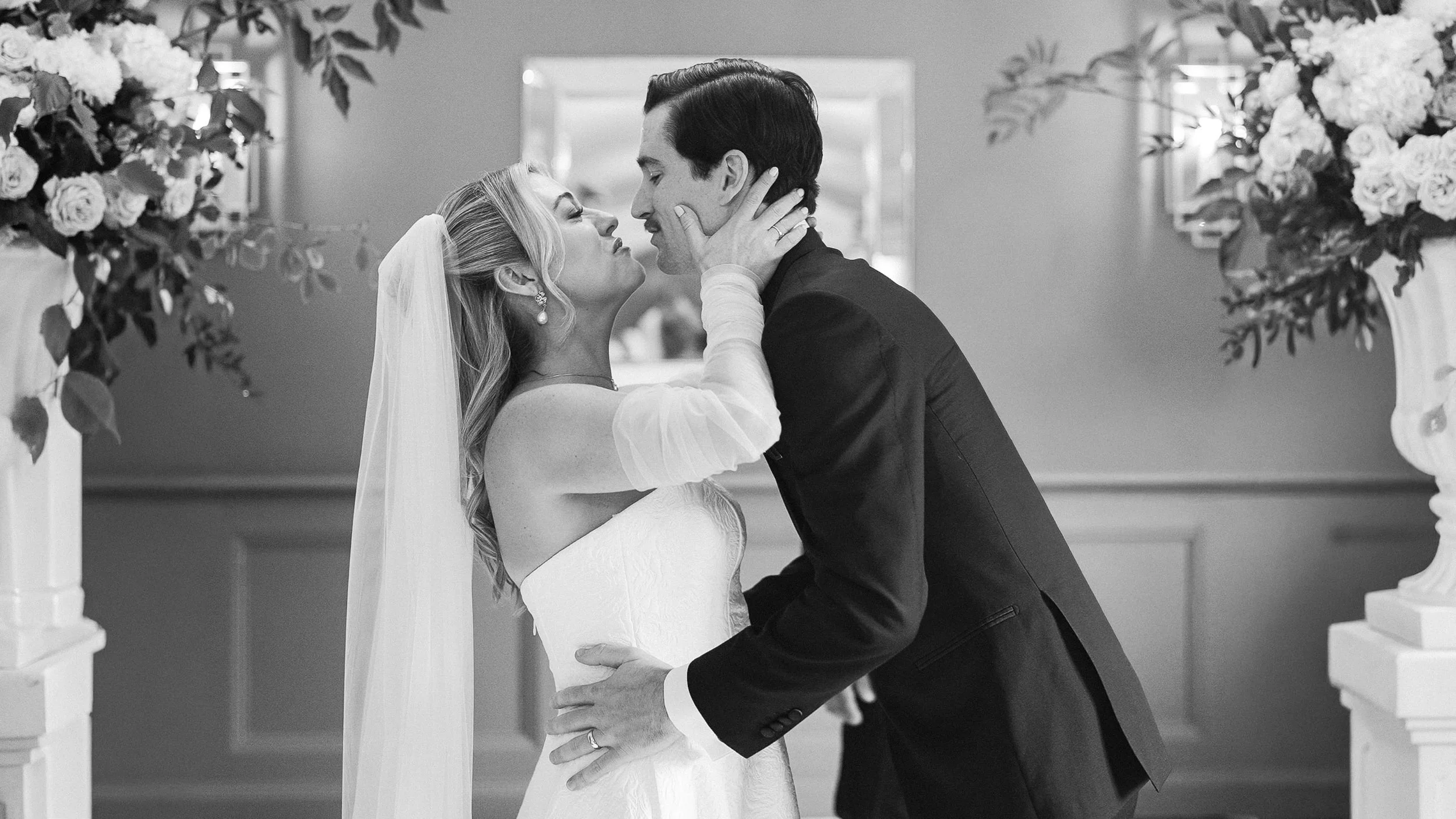 Black and white photo of the first kiss at a Kilkea Castle wedding ceremony, Co. Kildare