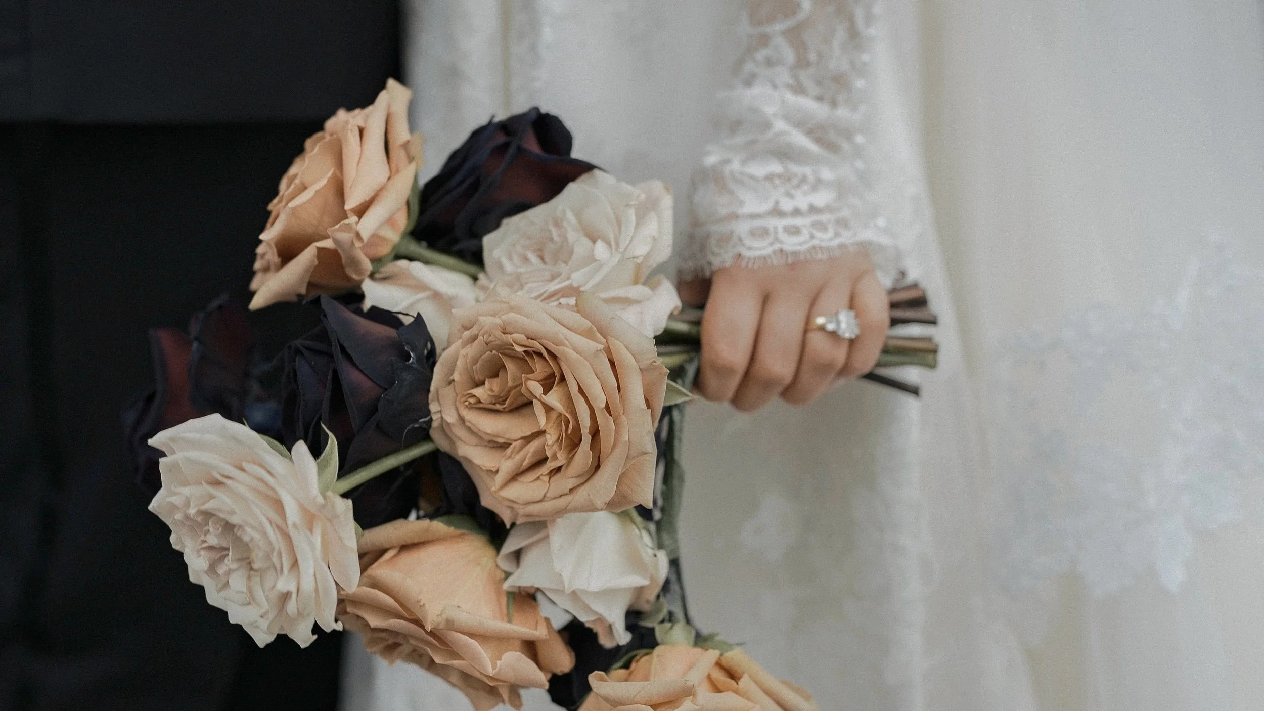 Bridal bouquet of toffee, ivory and burgundy roses with engagement ring and lace sleeve, Kilkea Castle wedding