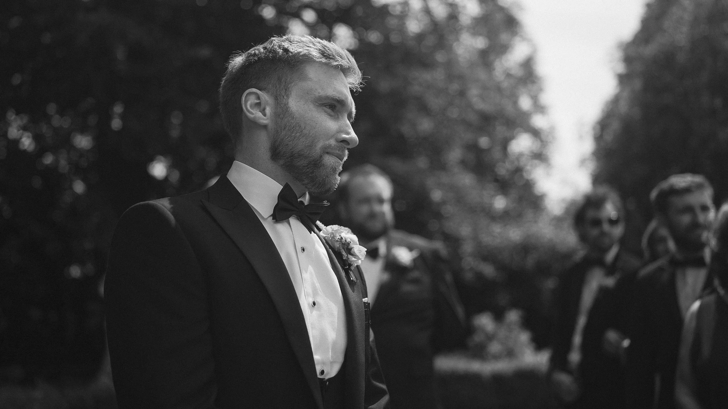 Groom waiting for his bride at the outdoor garden ceremony at Tinakilly Country House, black and white