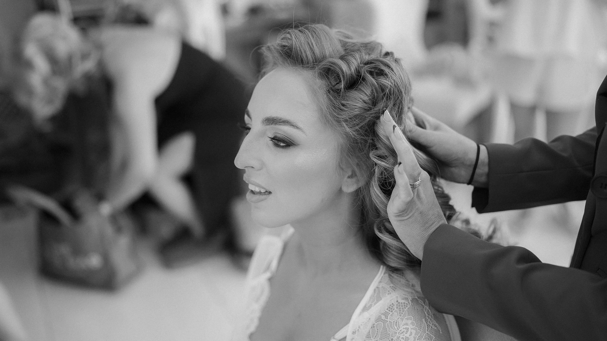 Black and white photo of bride Emma having her vintage waves styled on her Crover House Hotel wedding morning