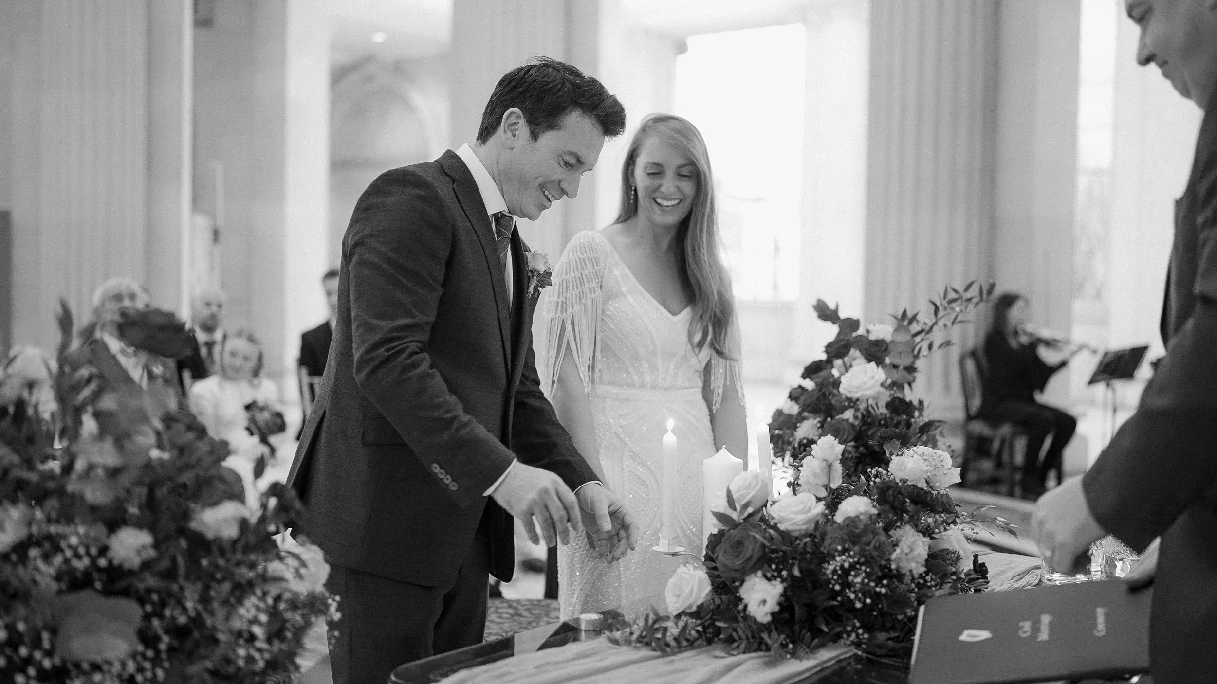 Bride and groom lighting a candle during their wedding ceremony at Dublin City Hall, black and white
