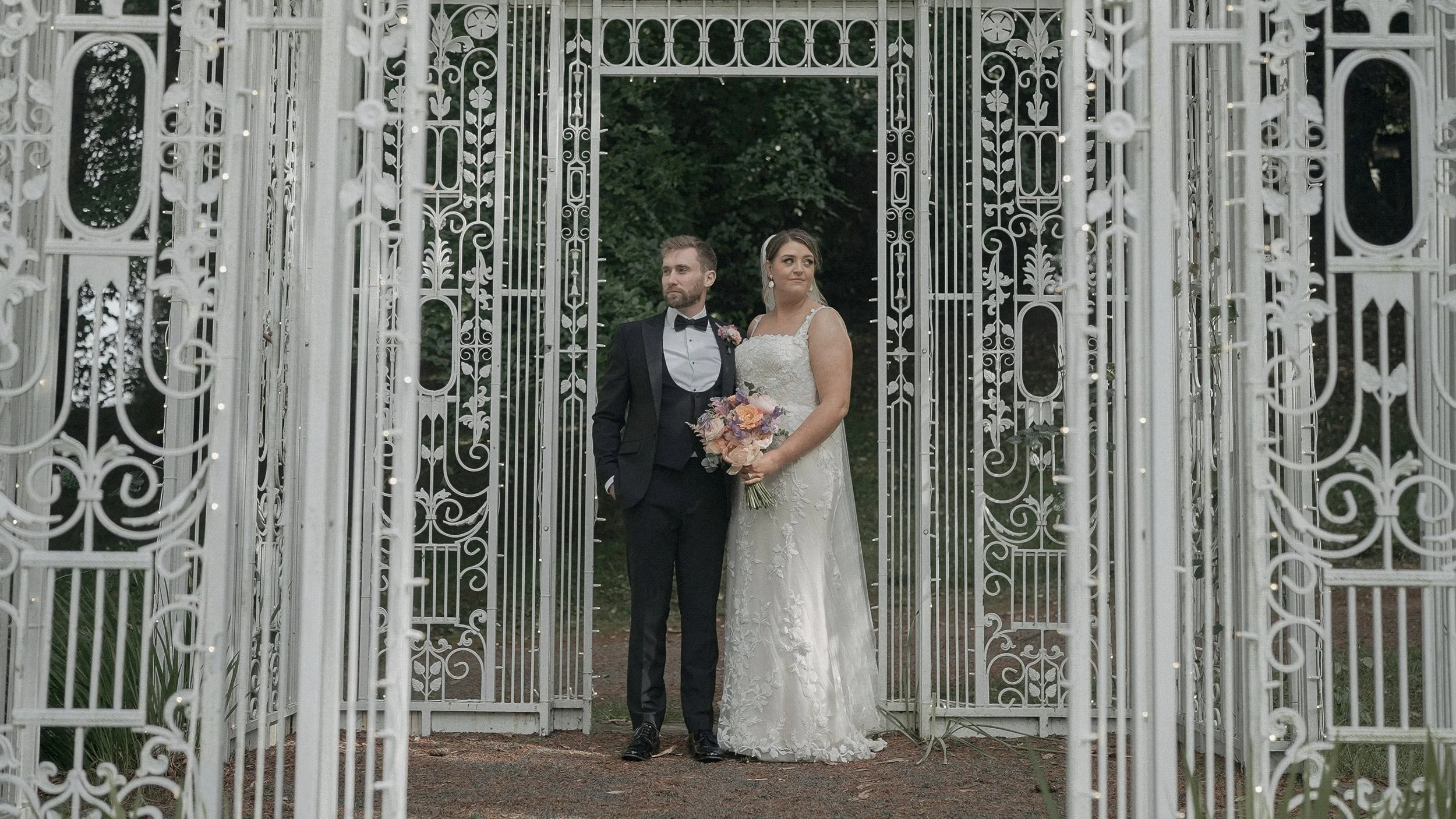 Bride and groom inside the white wrought-iron garden pavilion at Tinakilly Country House