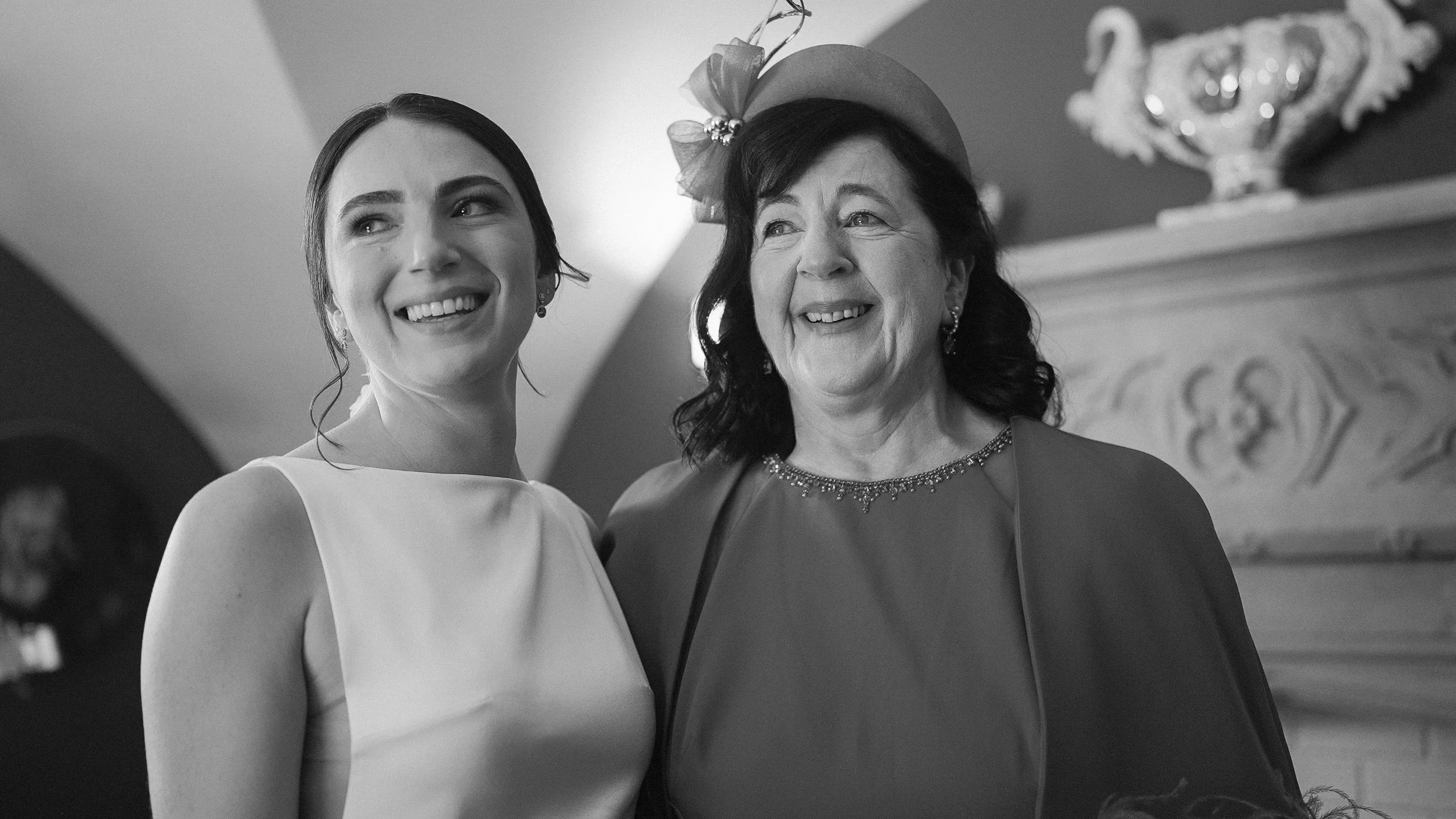 Smiling bride with her mother before the ceremony at Markree Castle, Co. Sligo, black and white