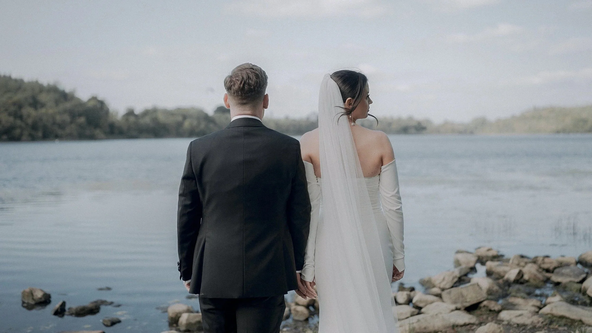 Bride and groom looking out over the lake at Farnham Estate, Co. Cavan