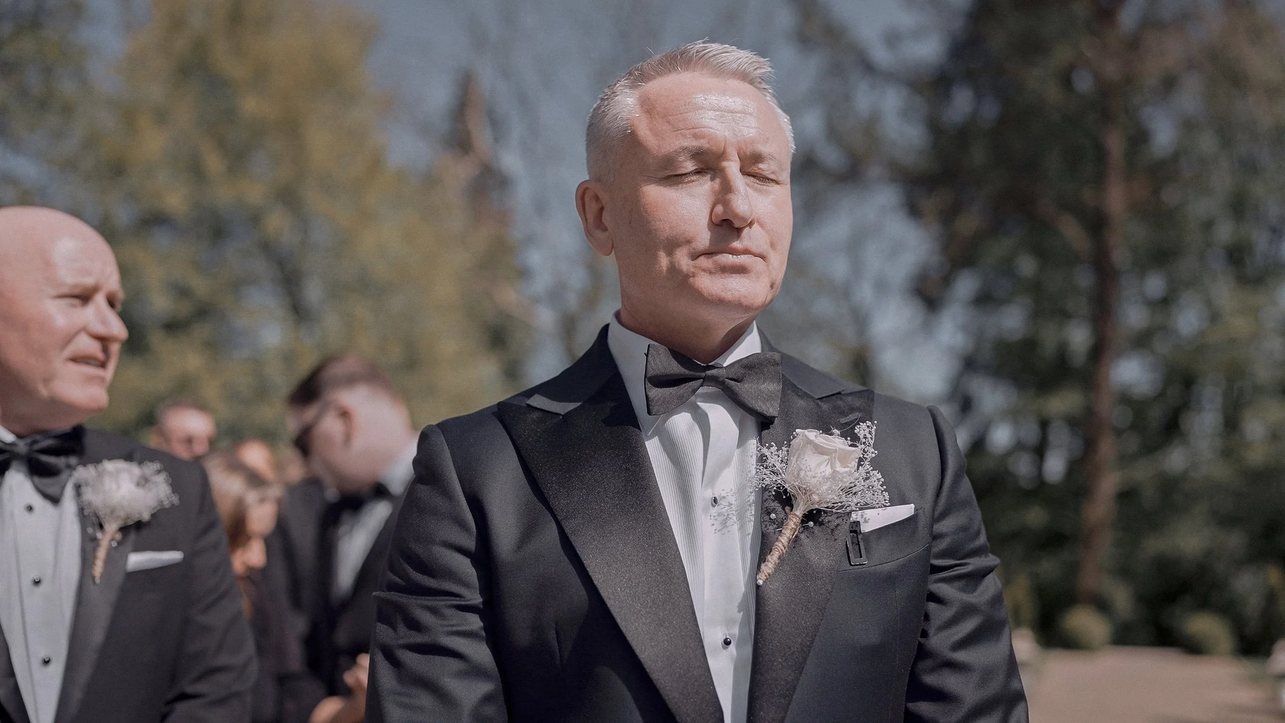 Groom in a black tuxedo waiting for his bride at an outdoor ceremony at Clonwilliam House, Co. Wicklow