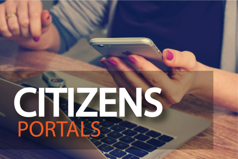 Person holding smartphone with a laptop on a wooden desk, overlay text reads 'Citizens Portals'.