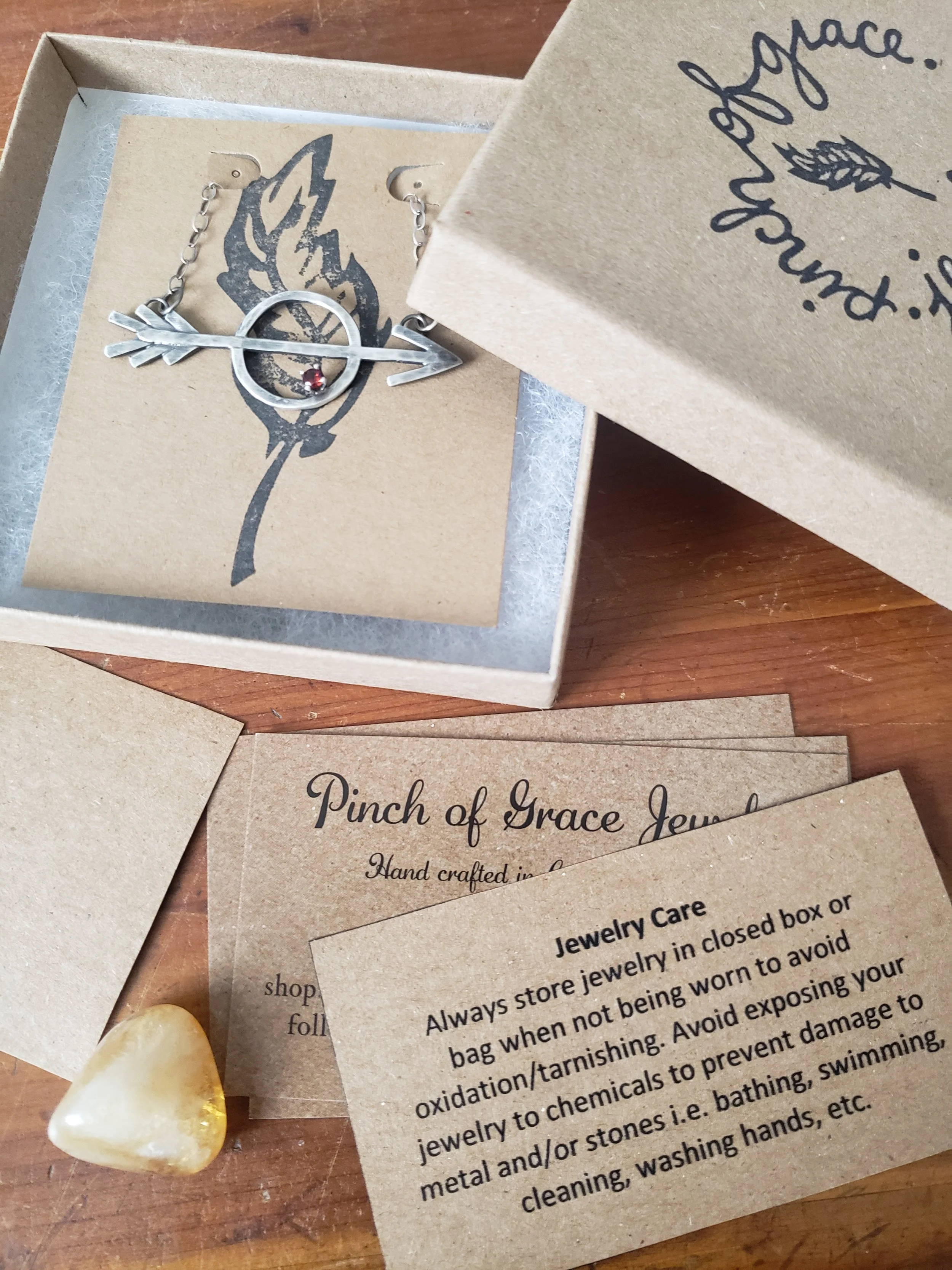 silver arrow with garnet