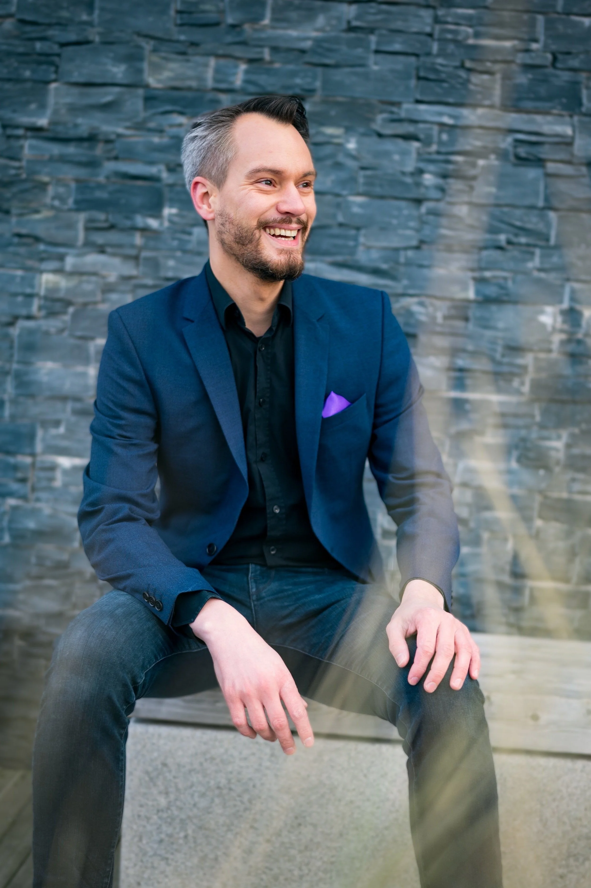 Man laughing in suit