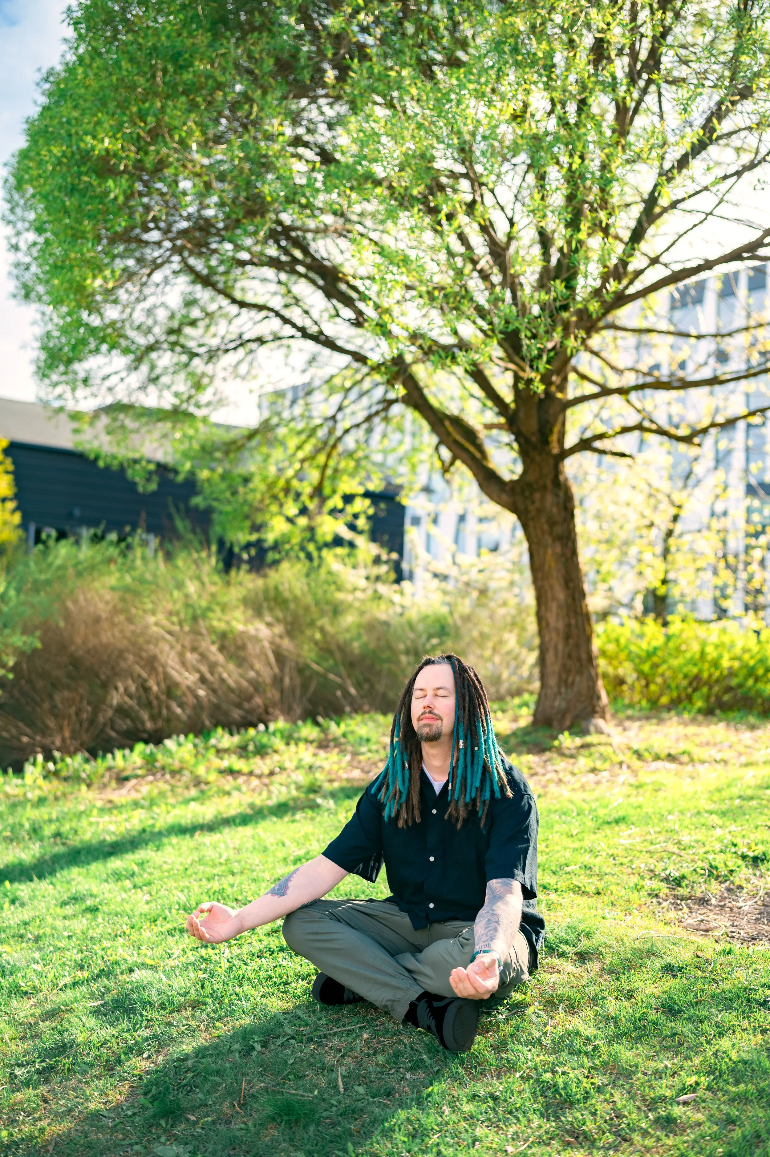 man meditating under a tree