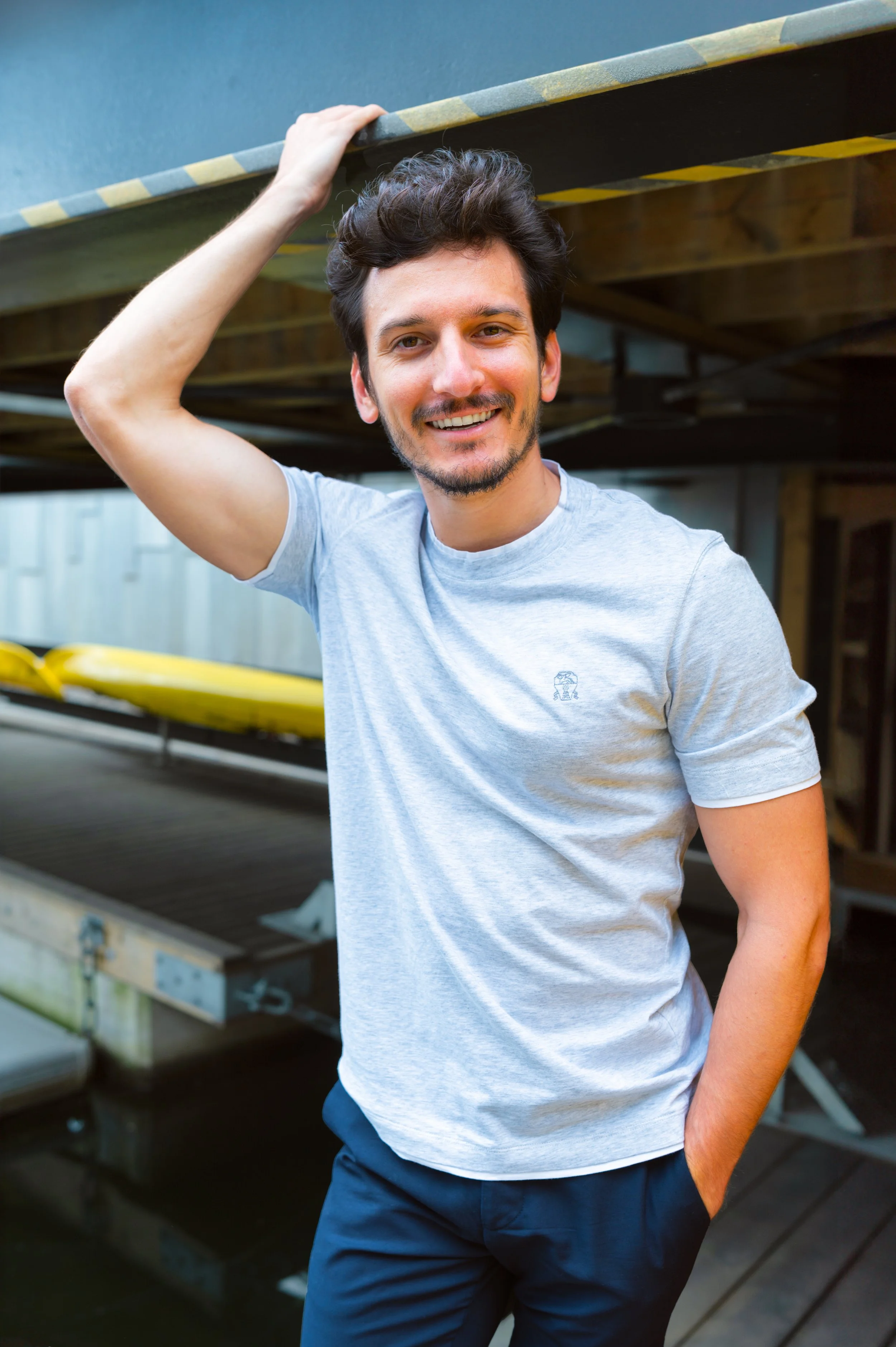 man standing in front of a kayak