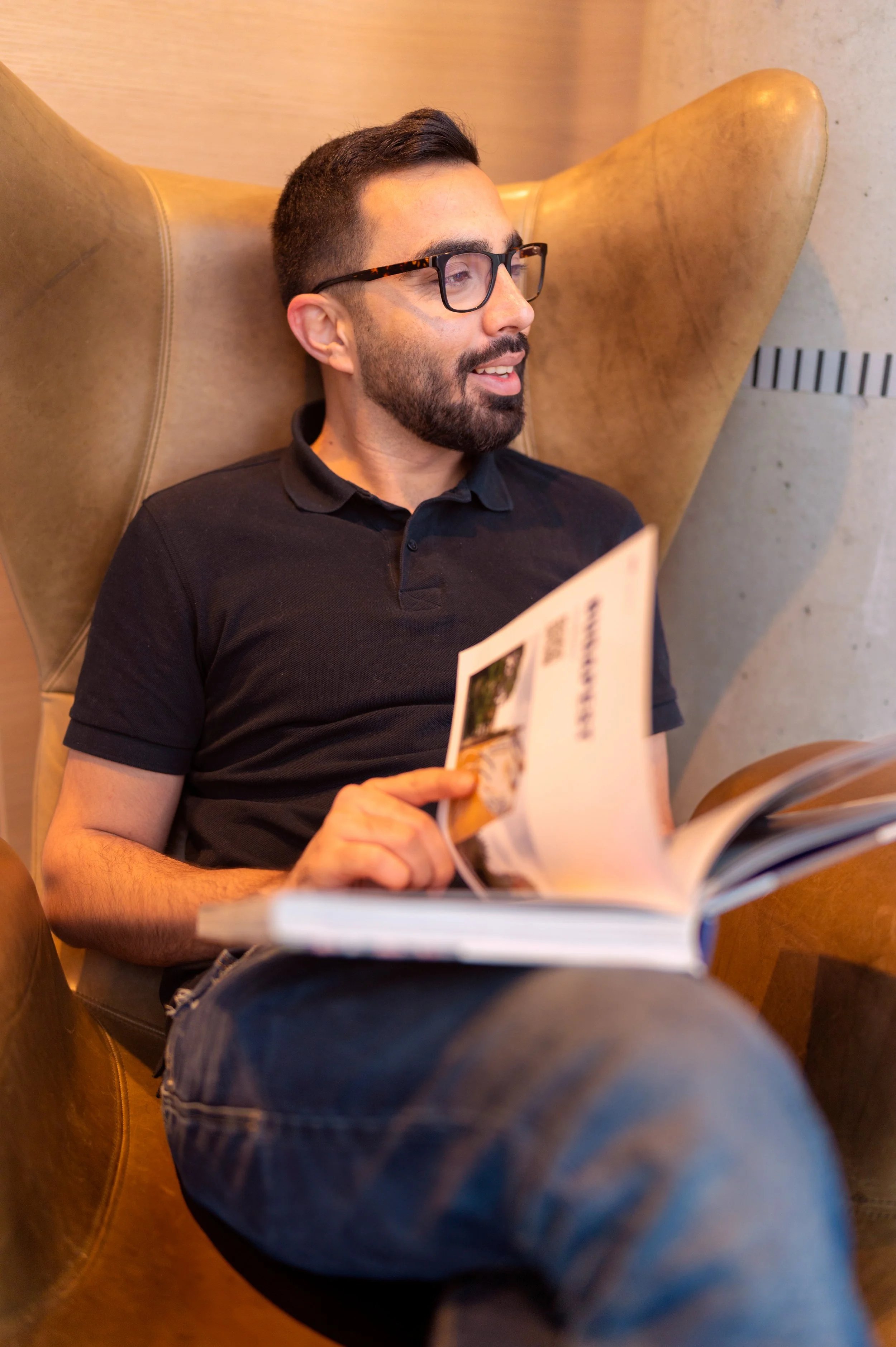 man reading book in library