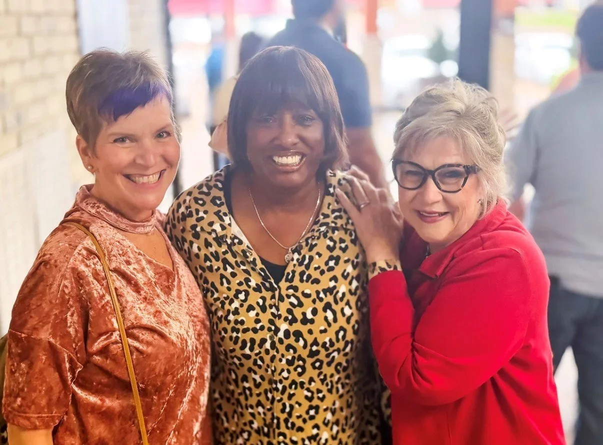 Three women smiling at The Sycamore Church in Tupelo, MS