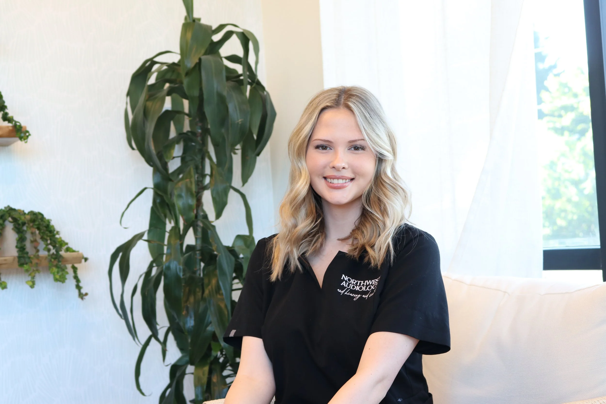 smiling audiology assistant excited to see patients