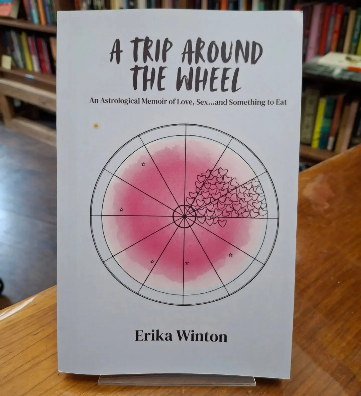 New on our local author shelf: A Trip Around the Wheel is an astrological memoir of love, sex...and something to eat.

Part dating disaster stories, part memoir, part astrological experiment, A Trip Around the Wheel follows storyteller Erika Winton a