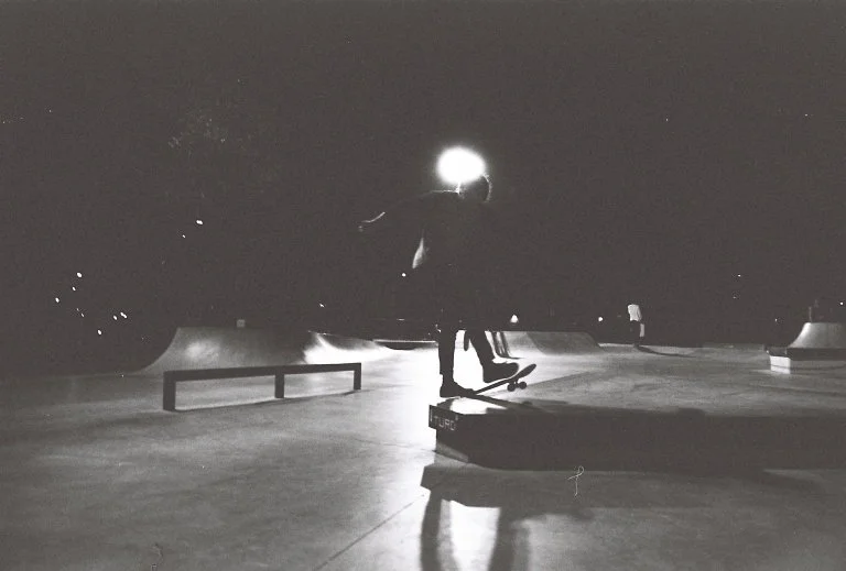 A skater mid-trick taken with a fast shutter at night