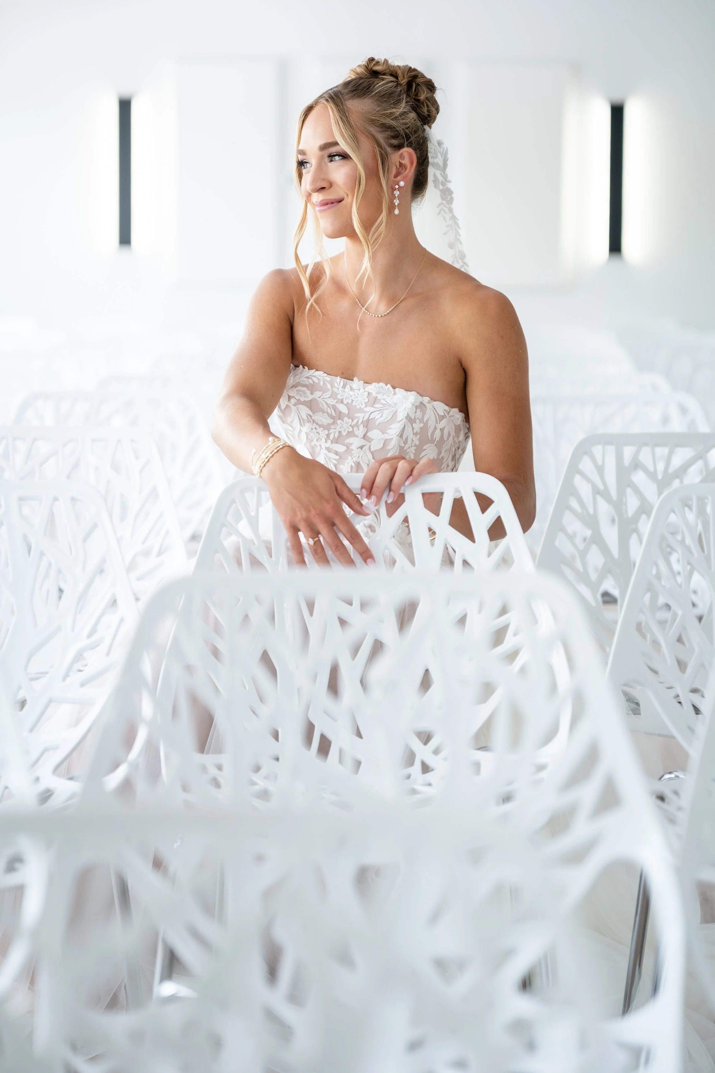 Beautiful bride sitting in bright modern room.