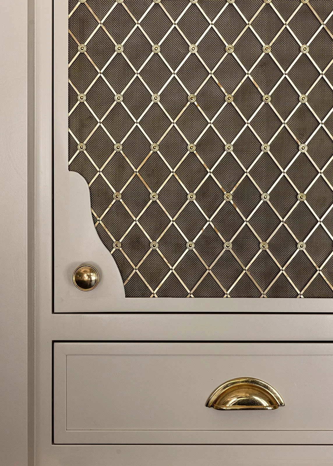 Gold details including cabinet hardware and a gold mesh door