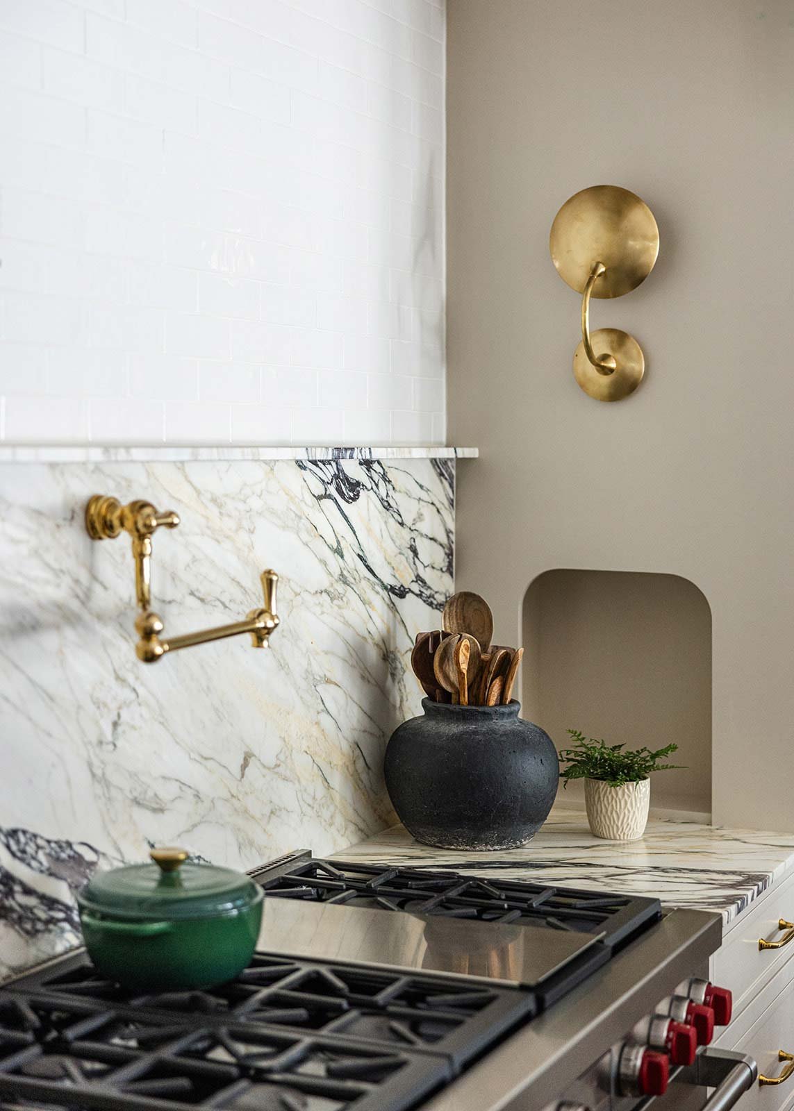High-end kitchen renovation in Indian Springs Alabama showcasing a gold pot-filler above range