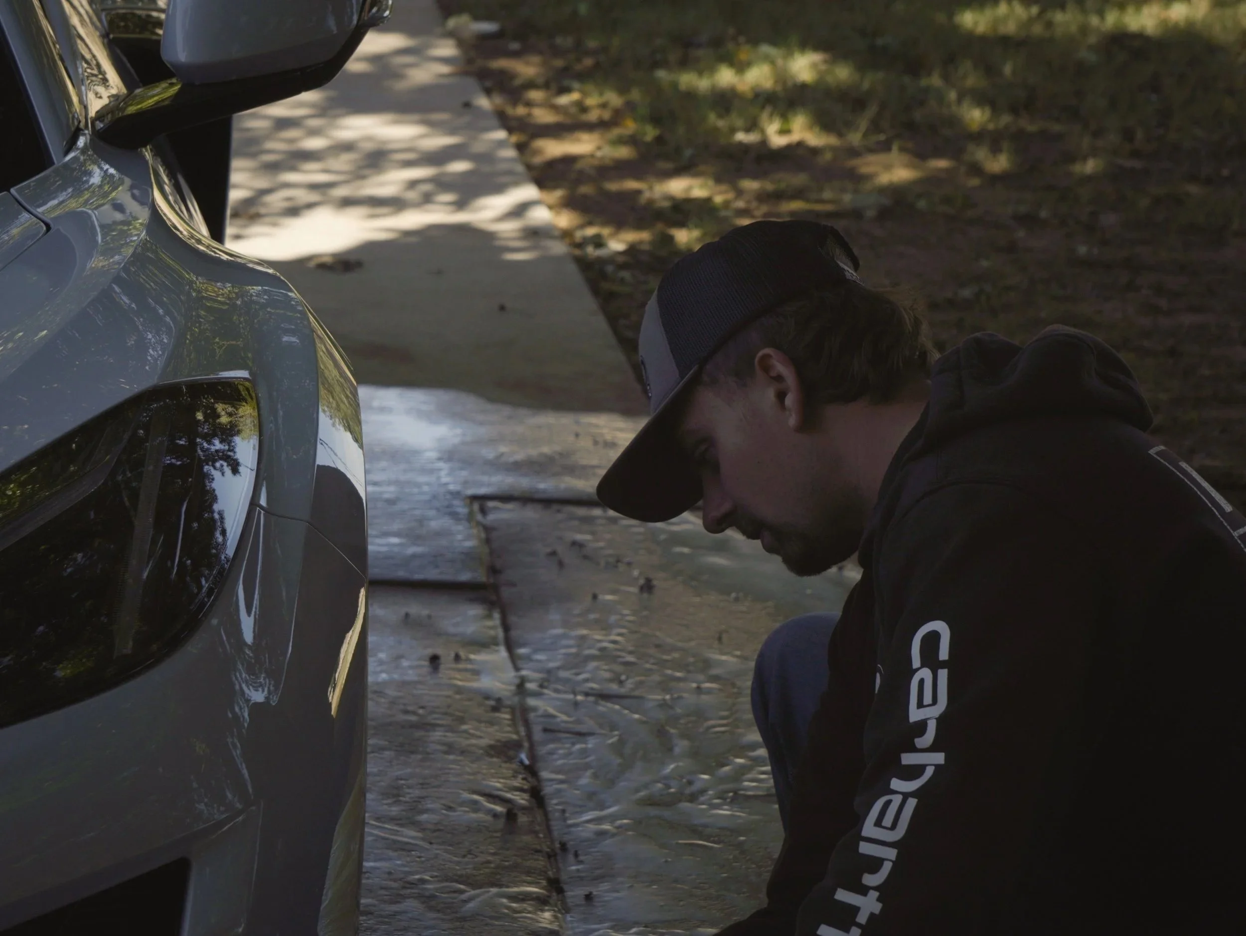 Dawson cleaning the wheels of a corvette