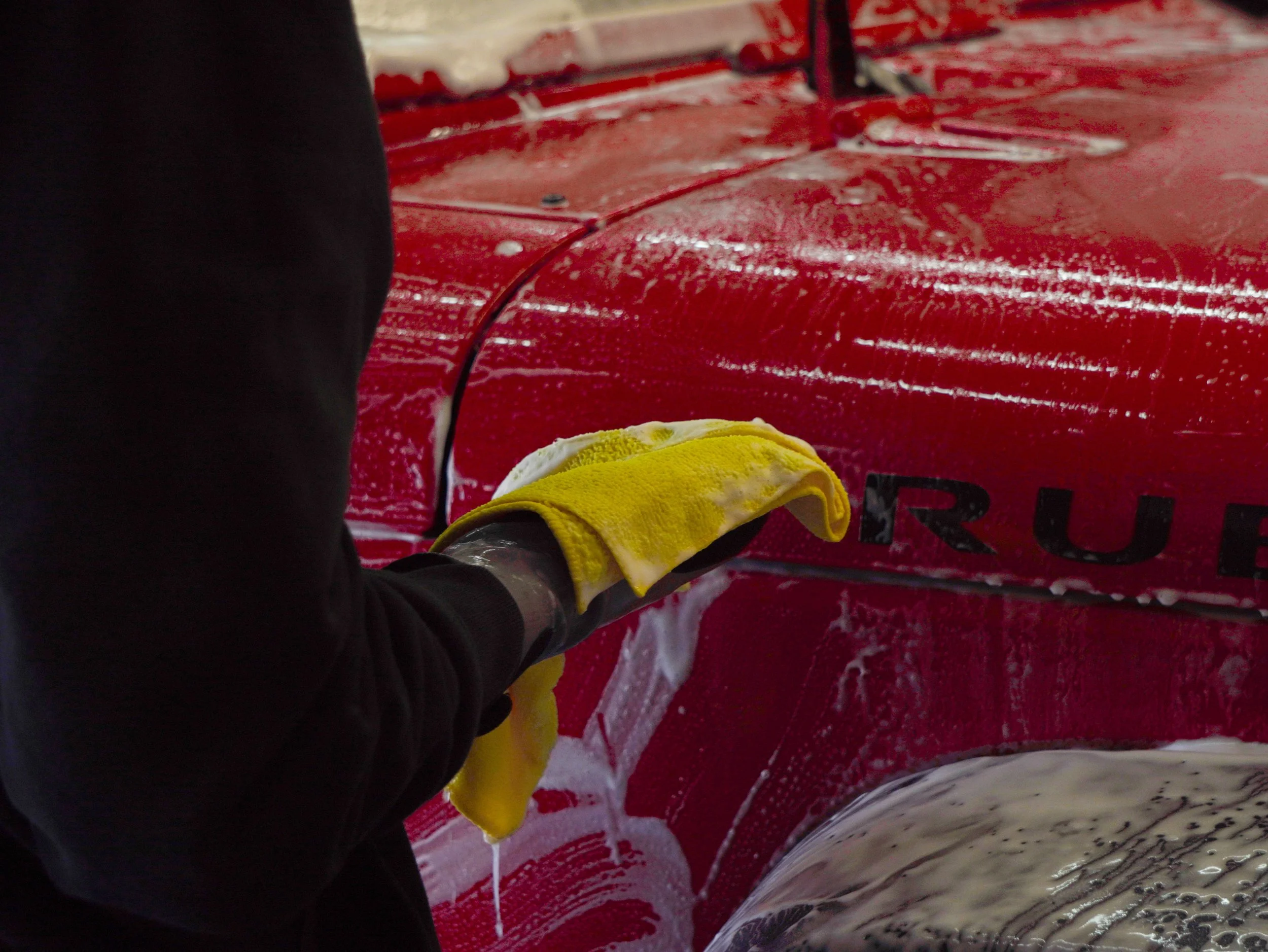 Exterior hand wash and detailing on a red Jeep