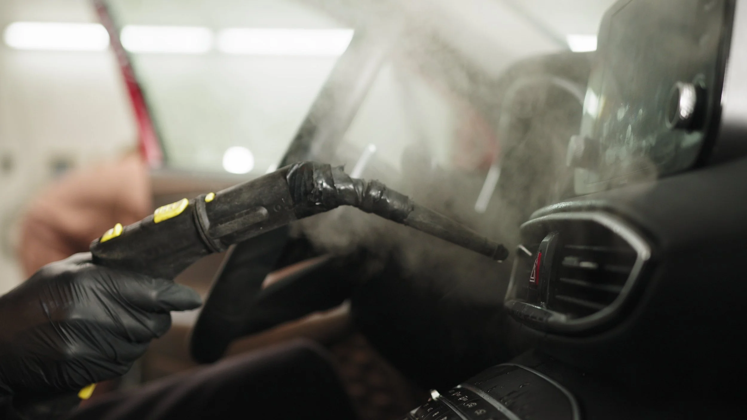 Hand steaming a vent during a car detail