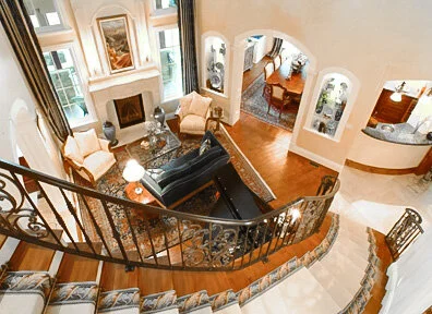 Luxury Colorado Springs custom home with grand curving staircase into great room. 