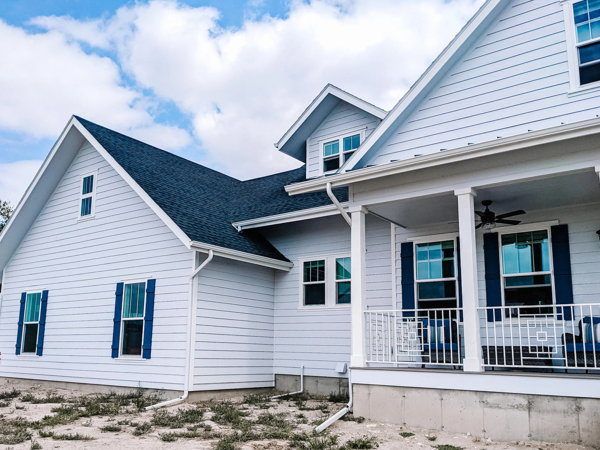 Modern farmhouse exterior with covered deck.