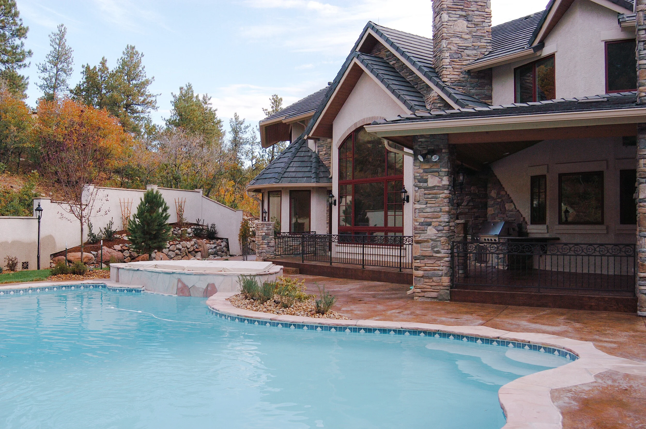 Colorado Springs transitional lodge style home with pool.