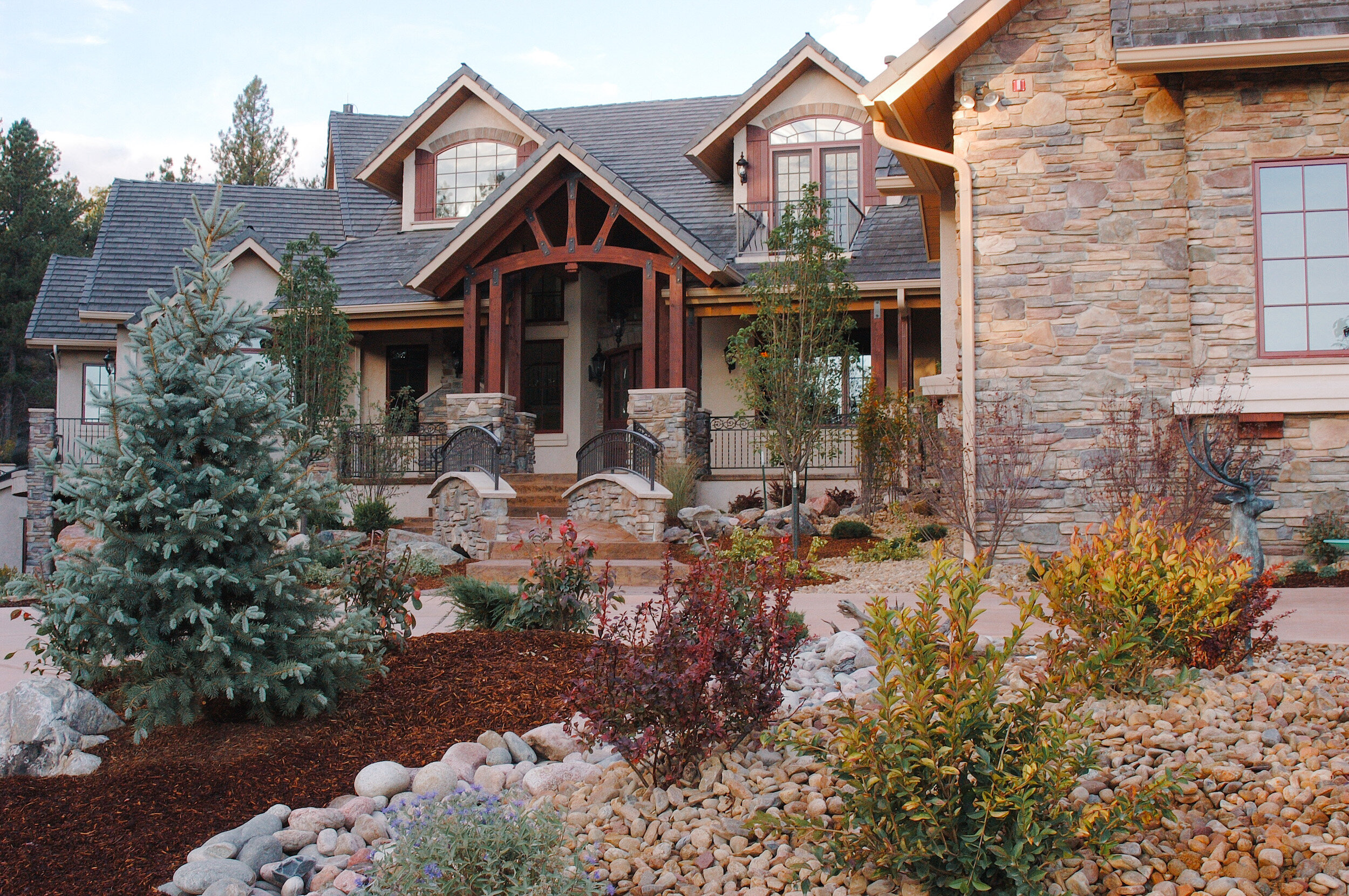 Truss entry and European lodge style shutters and stone work on a Colorado Springs custom home.