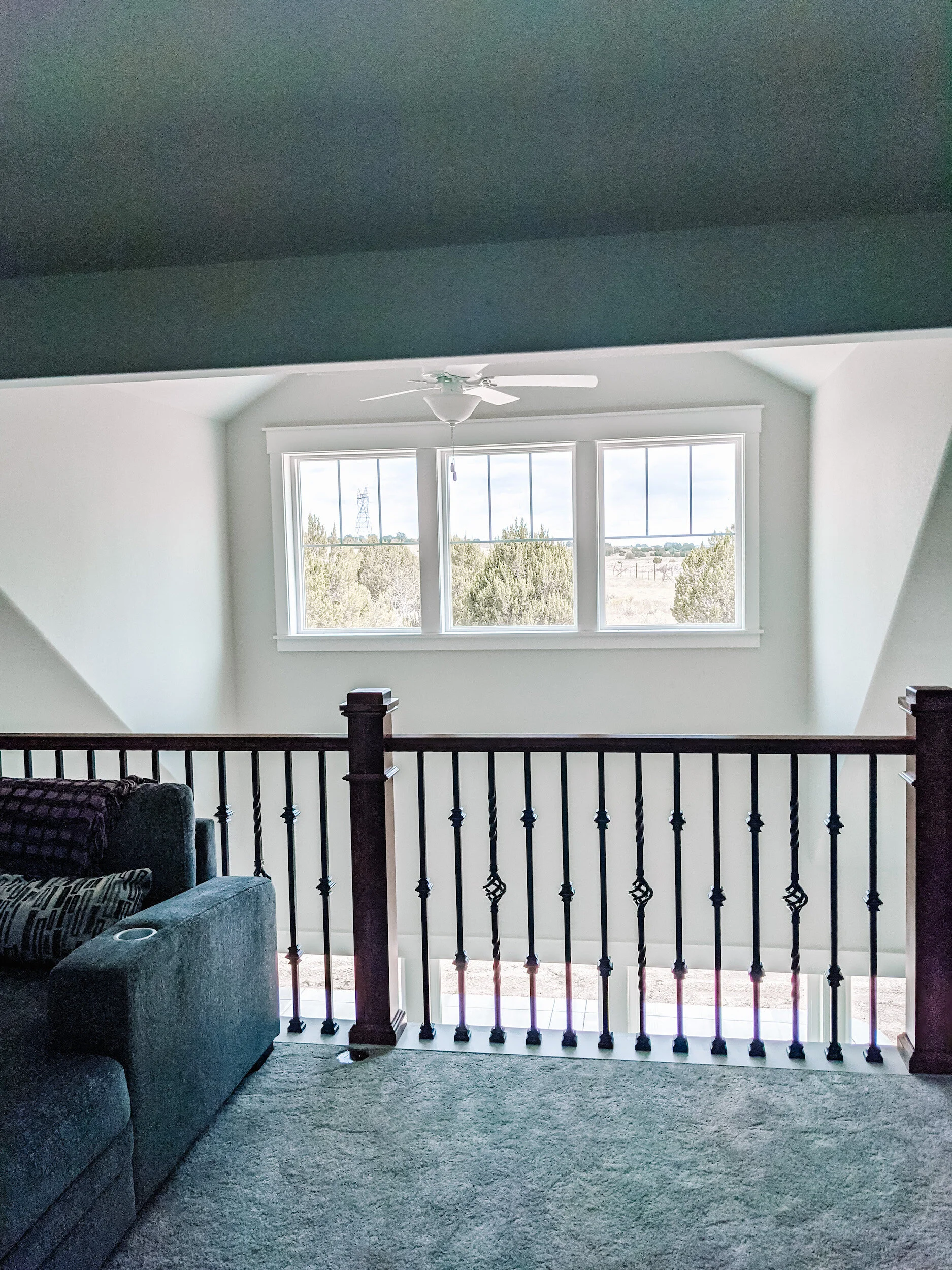 Modern farmhouse upper level loft with vaulted ceilings.