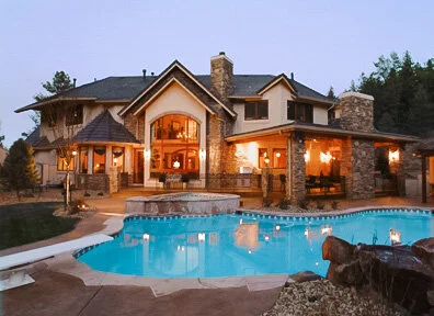 Luxury custom home with European lodge exterior style and pool.