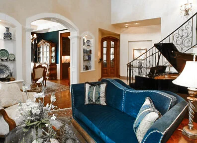 European style family room with piano in a custom home.
