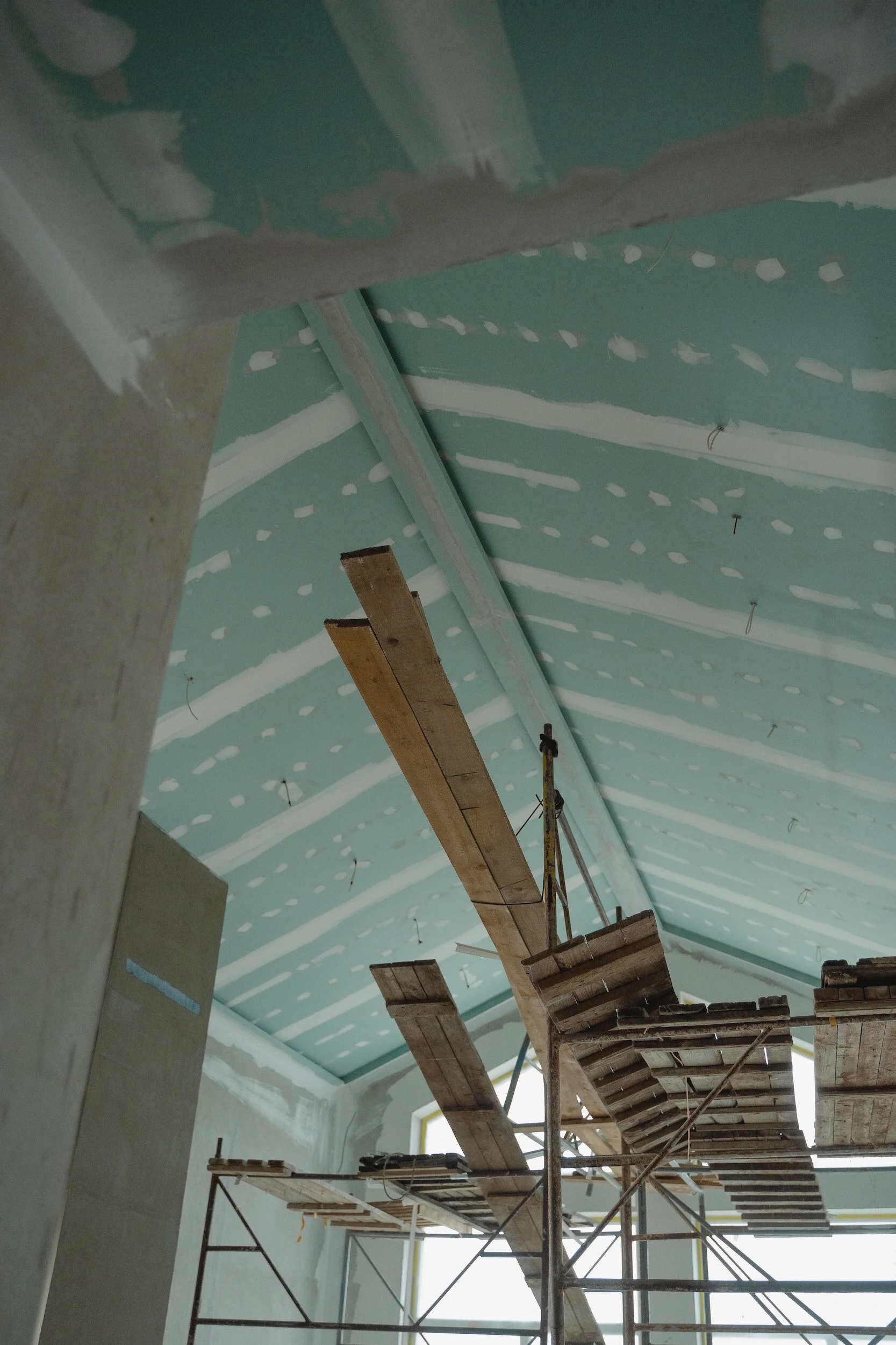 Interior construction site with scaffolding and unfinished ceiling