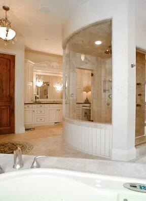 Curved European style primary suite bathroom.