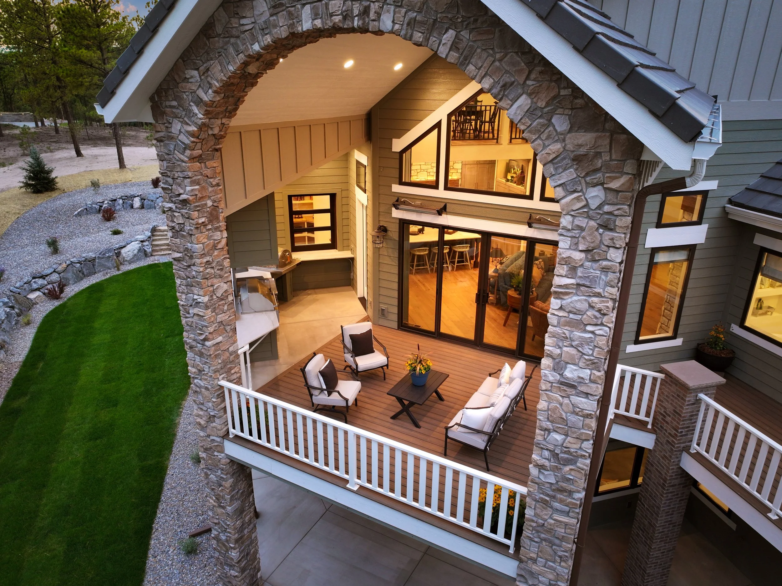 Outdoor living with covered deck in farmhouse style home. 
