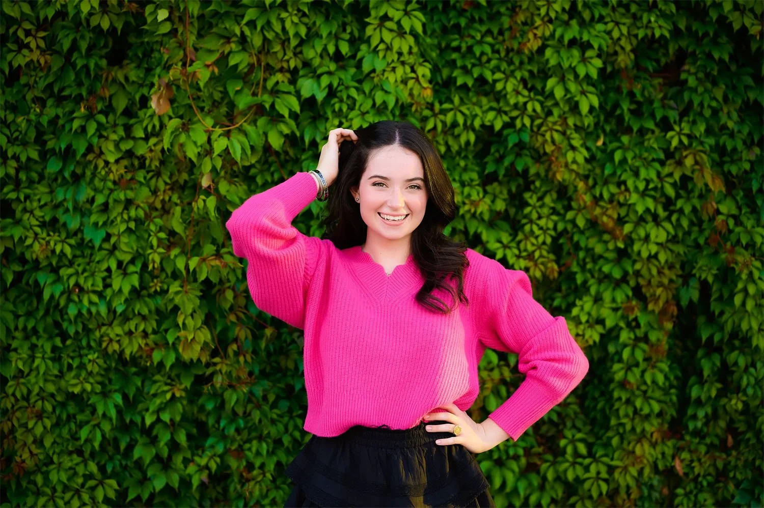 Teen girl in bright pink sweater fun Austin photo shoot High School senior