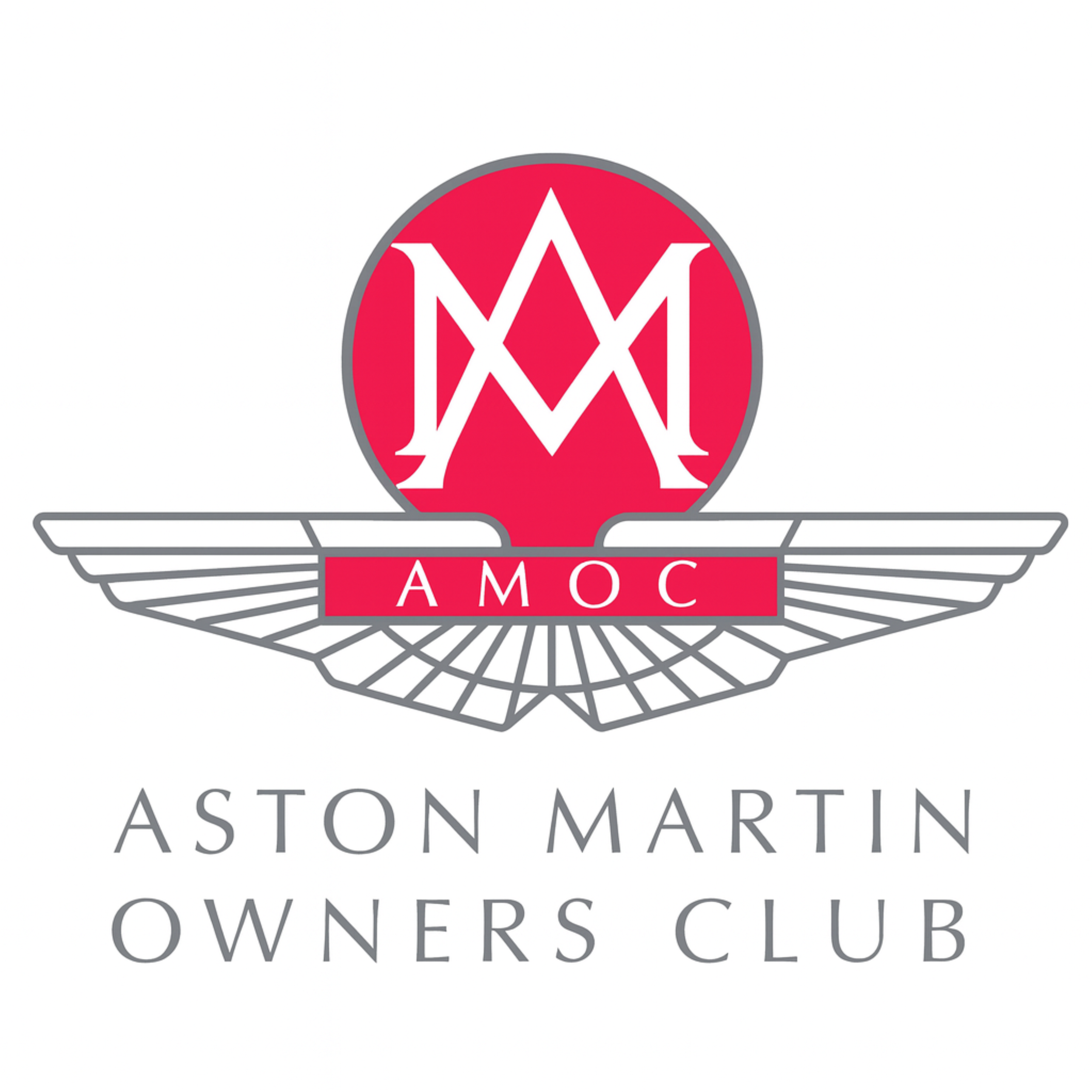 Logo of the Aston Martin Owners Club featuring a red circle with stylized white initials 'AM' at the center, wings extending from either side, and the acronym 'AMOC' on a red banner below the circle.