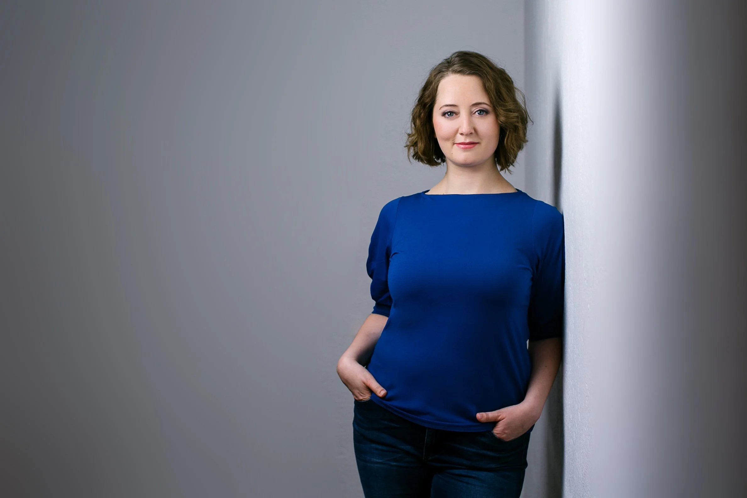 Portrait of Kinga in blue top with calm background