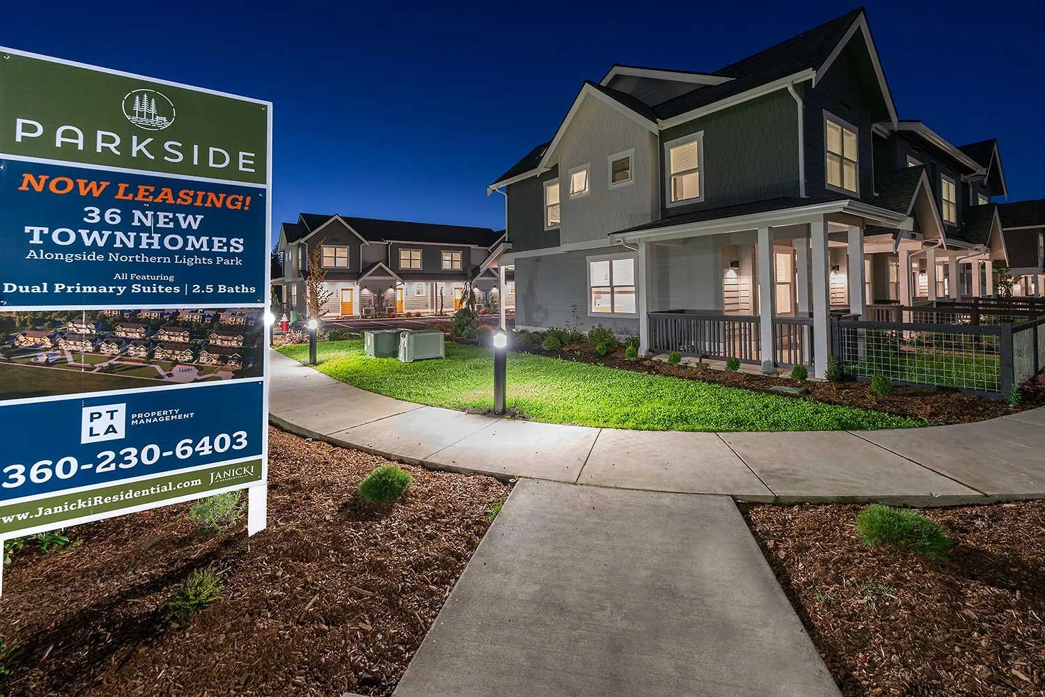 new homes with marketing sign in the foreground