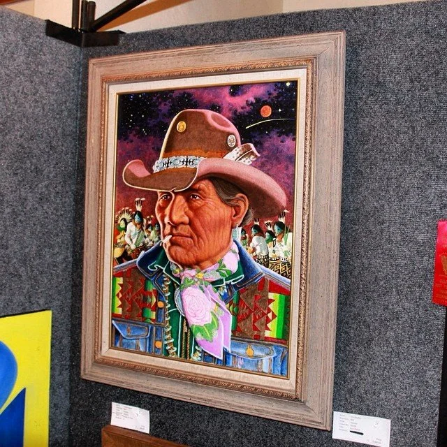 Colorful framed painting of a person wearing a hat and ornate clothing, displayed on a gray wall. Background features people and celestial imagery.